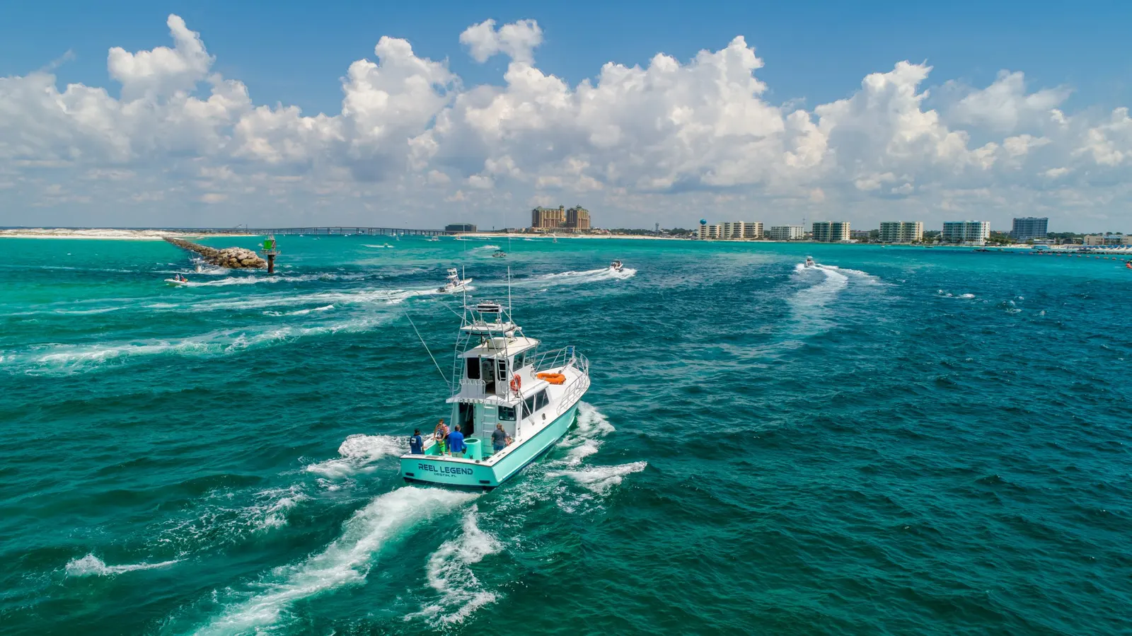 Aerial photograph of a boat crossing the turquoise water near Destin