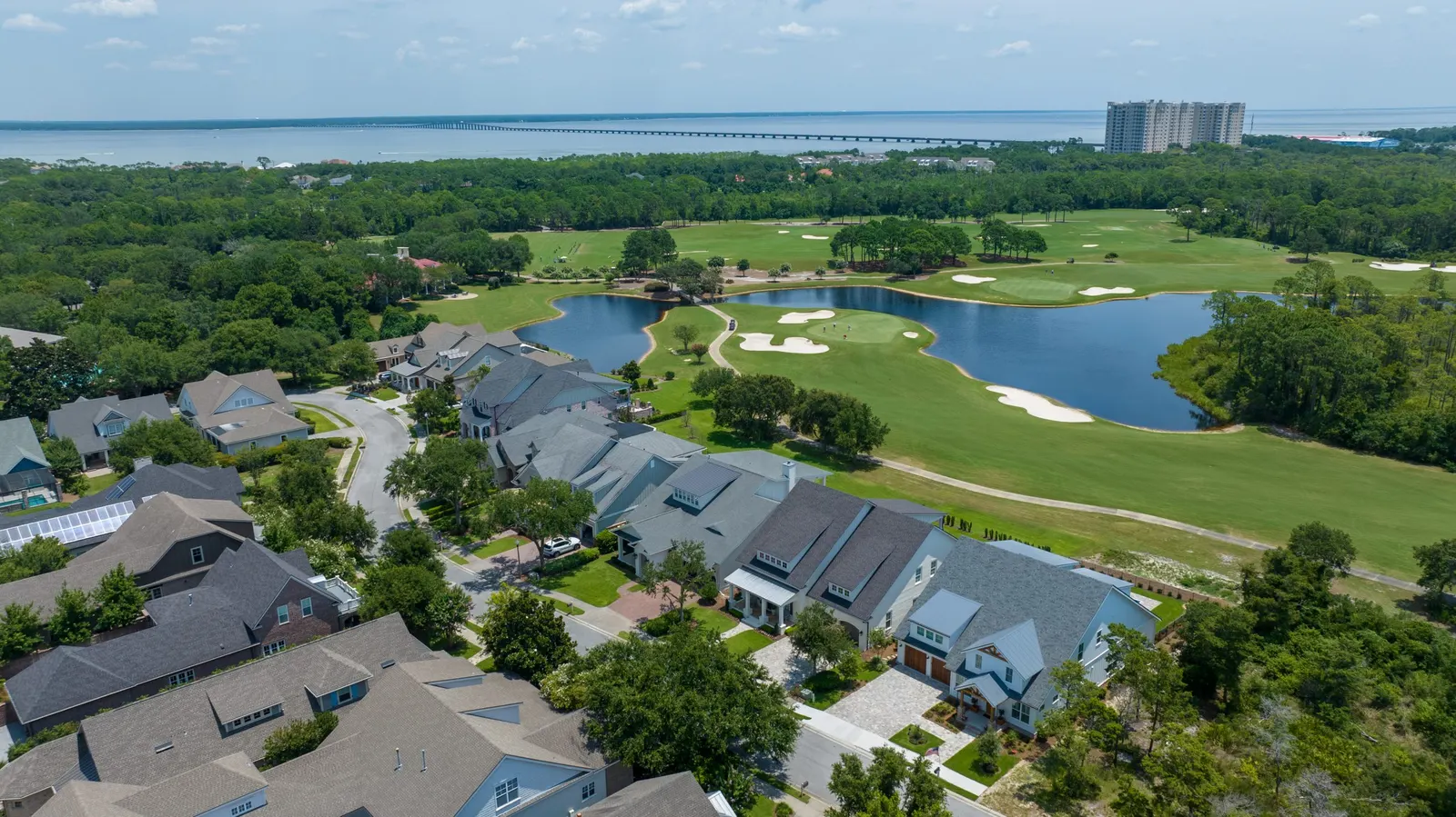 Homes, a golf course, and waterways seen from an aerial viewpoint