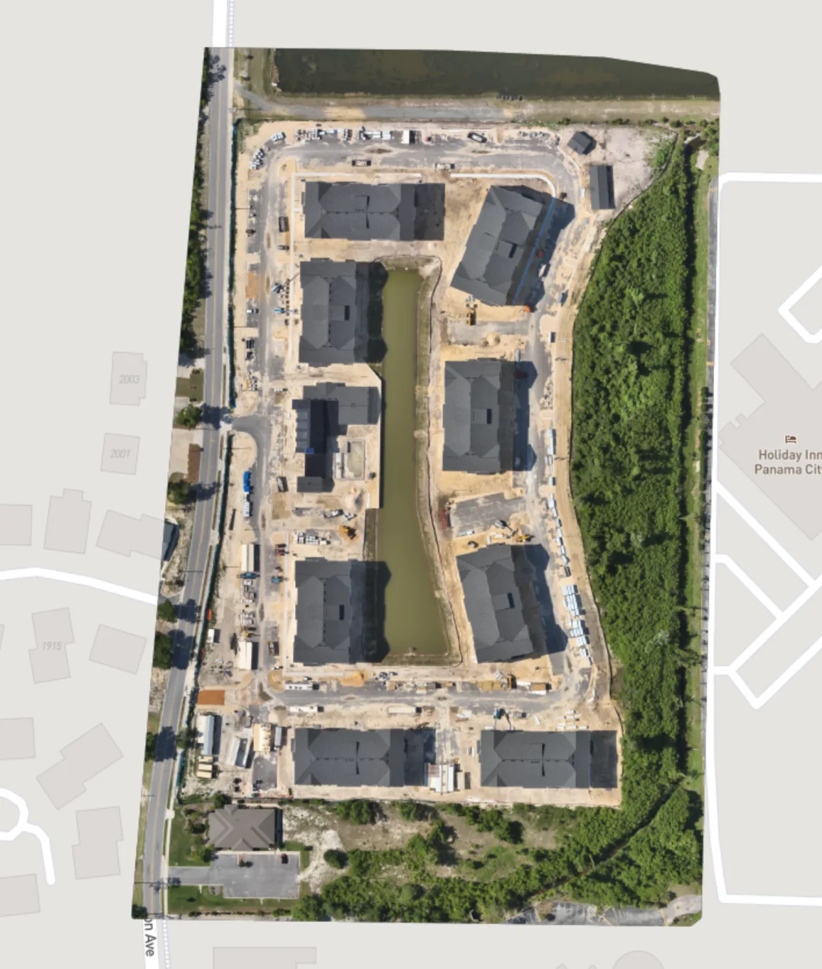 Mapped roofs, buildings, roads and active work areas in one overhead view.